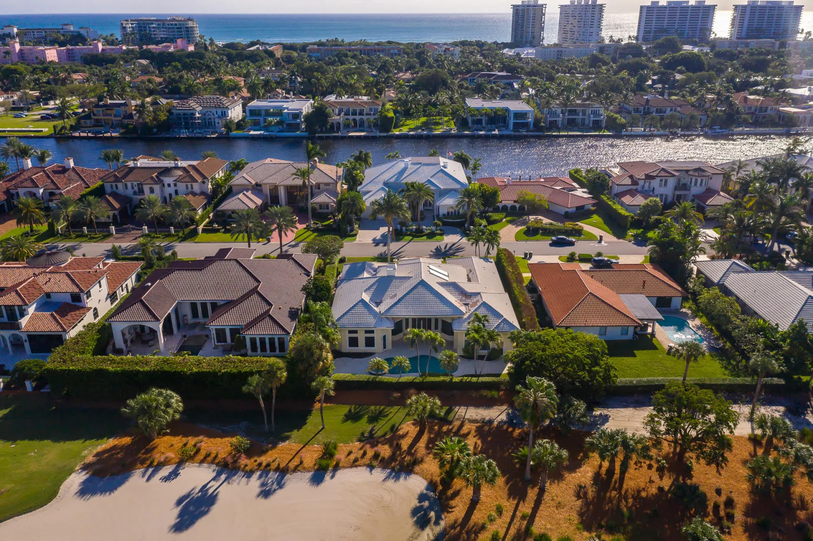 Aerial view of 1521 Royal Palm Way with the golf course to one side, the Intracoastal Waterway, Boca Raton’s barrier island and the Atlantic Ocean beyond