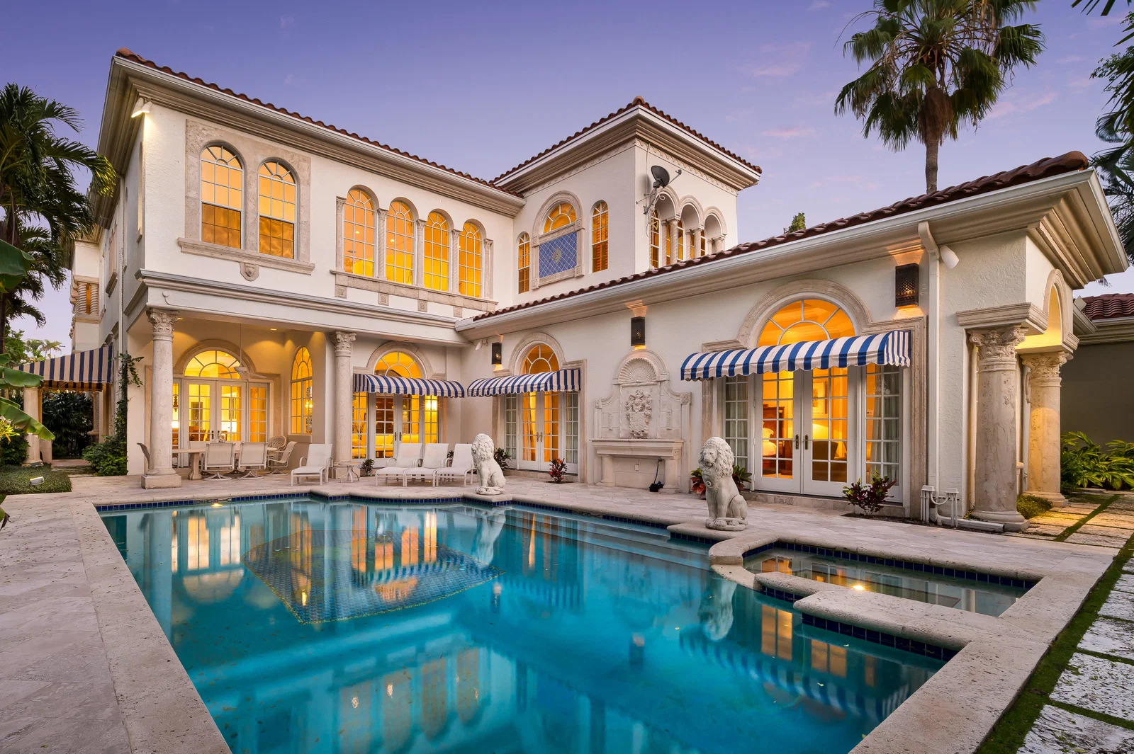 Addison Estates residence overlooking its pool at twilight