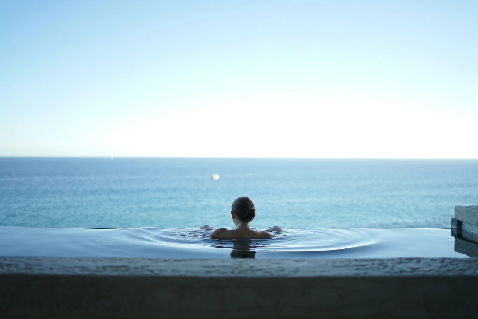 Infinity pool overlooking the ocean at dusk