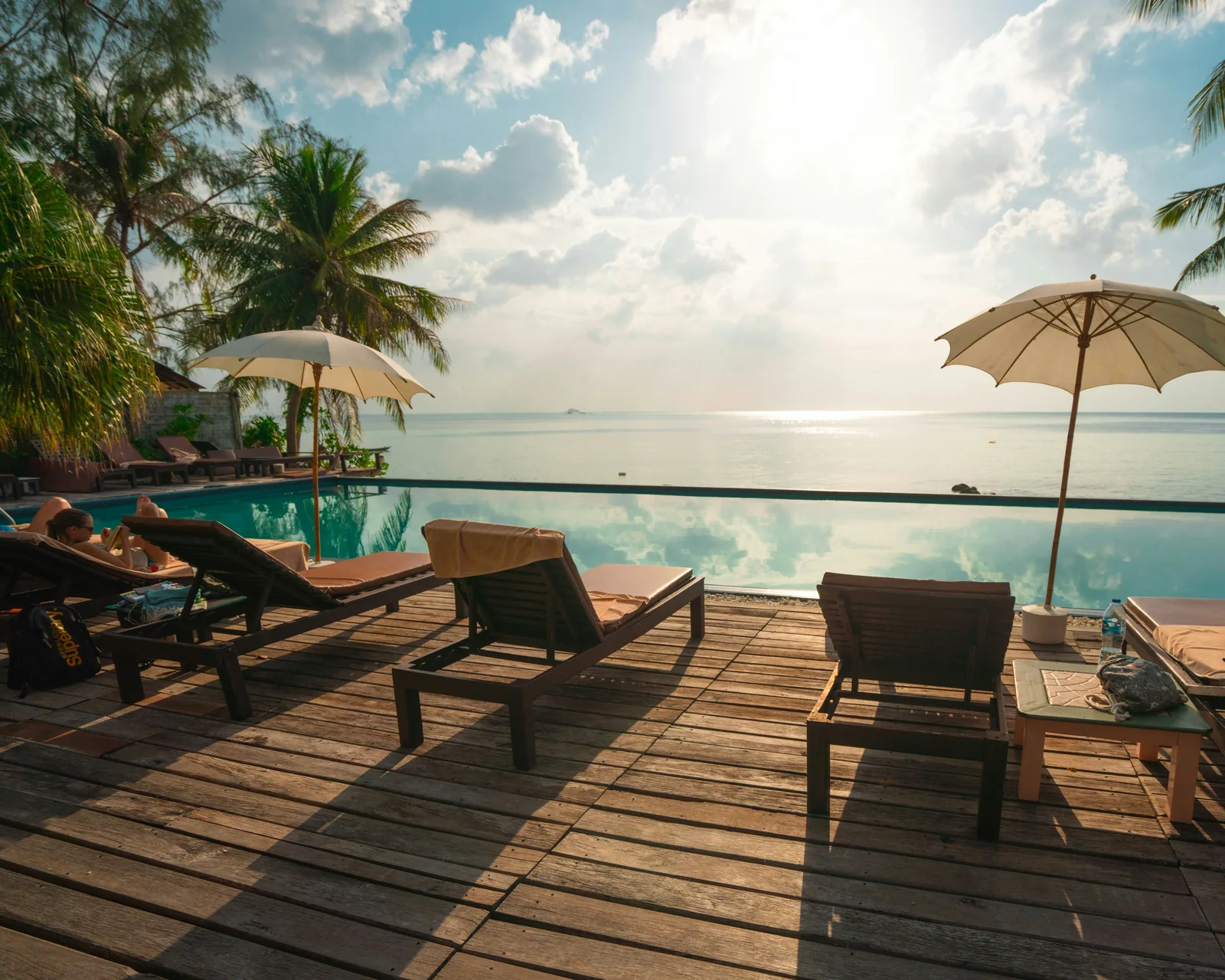 Waterfront luxury pool deck at sunset