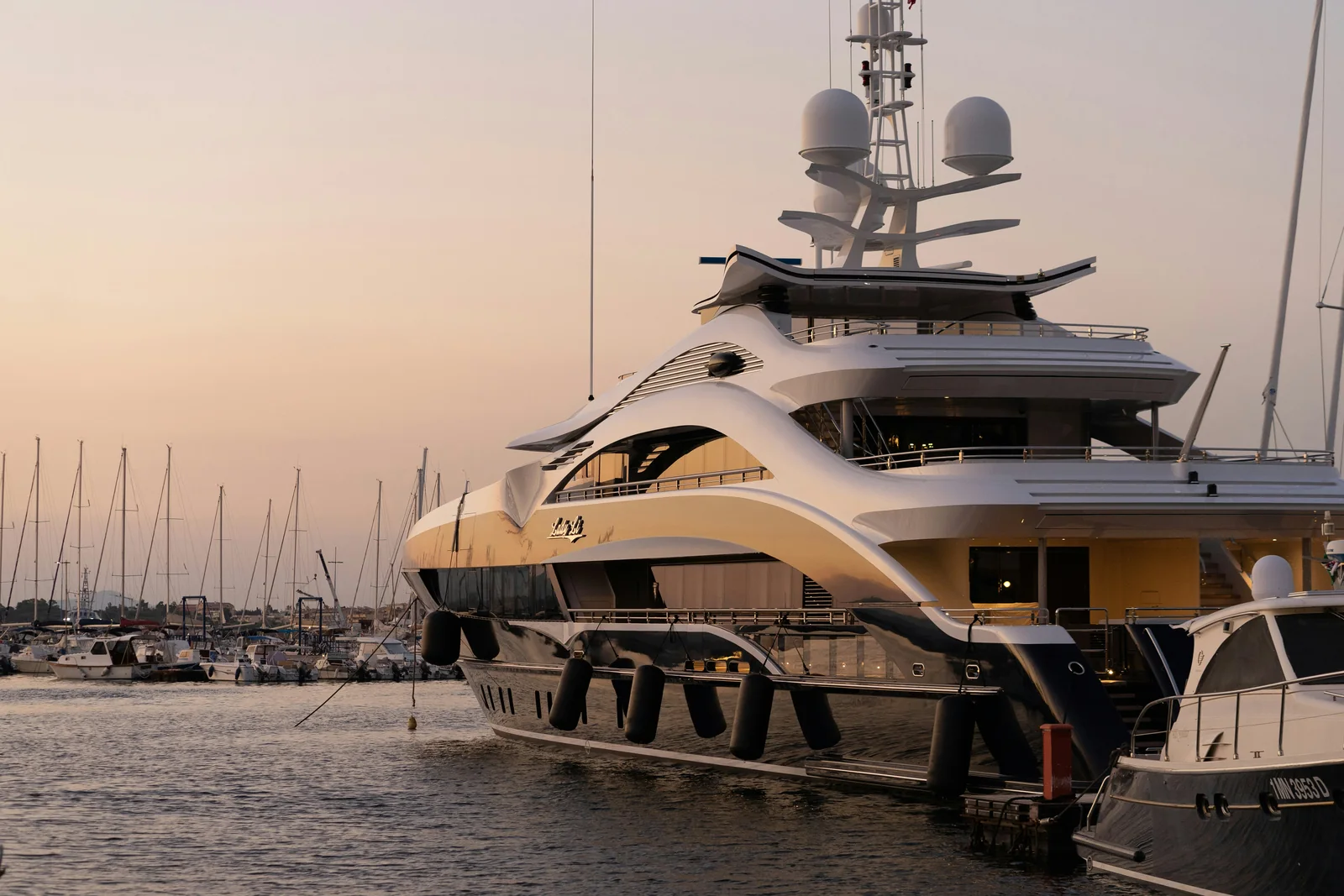 Luxury megayacht docked at a South Florida marina at golden hour